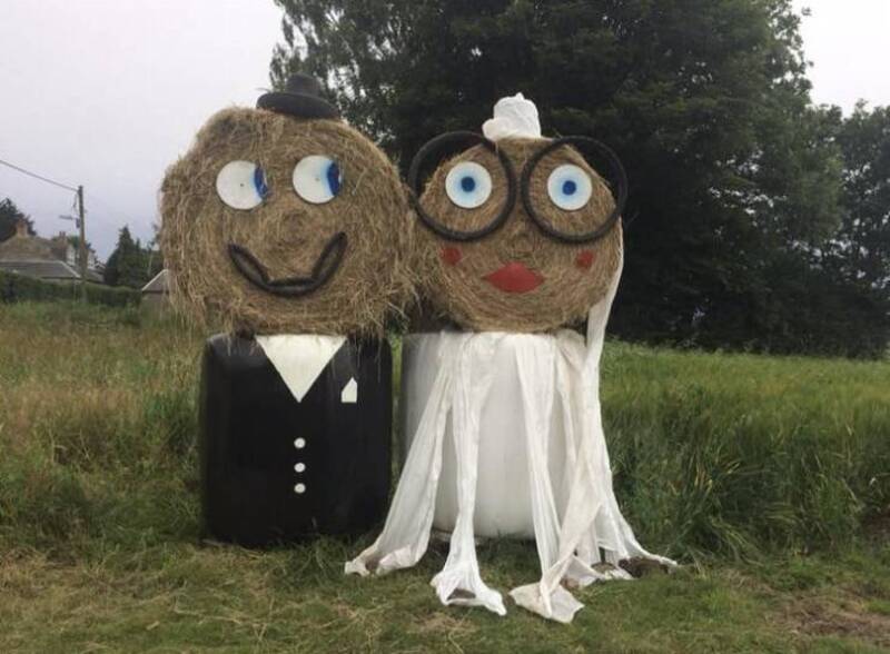 Funny scarecrow couple dressed as a bride and groom for Halloween.