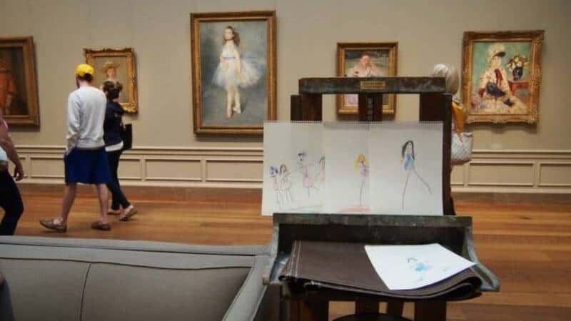 Children observing artwork in a museum setting.