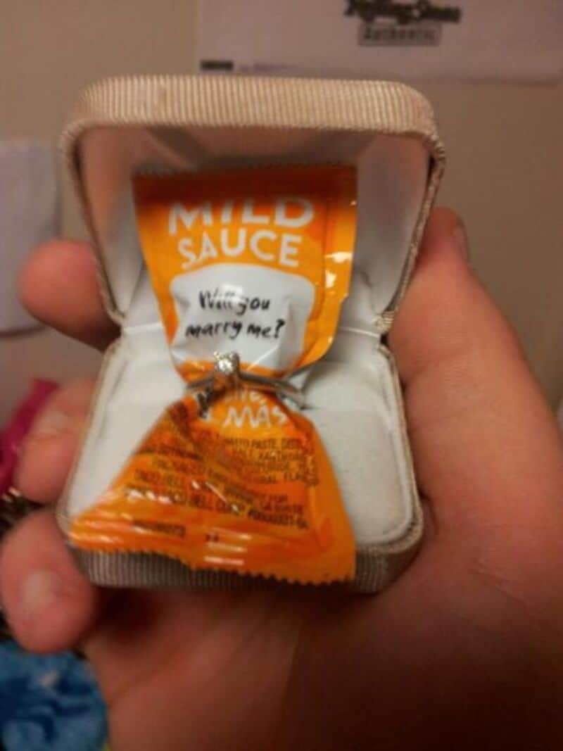Small packet of mild sauce held in hand, close-up shot.