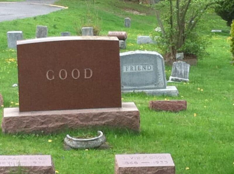 Gravestone inscribed with "Good" in a peaceful cemetery setting.
