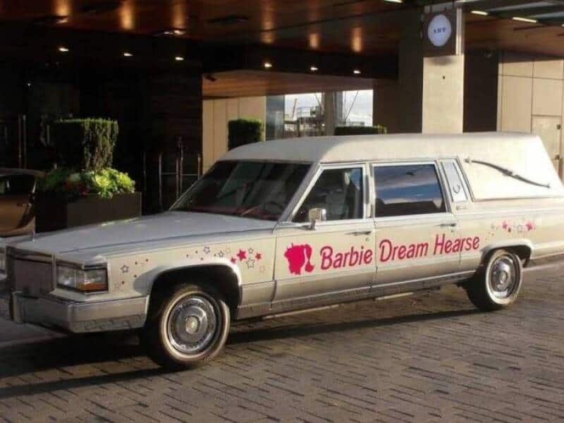 Vintage Barbie-themed hearse limousine with pink branding and decorative stars.