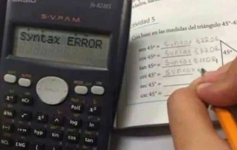 Calculator displaying "Syntax Error" with handwritten notes on a worksheet.