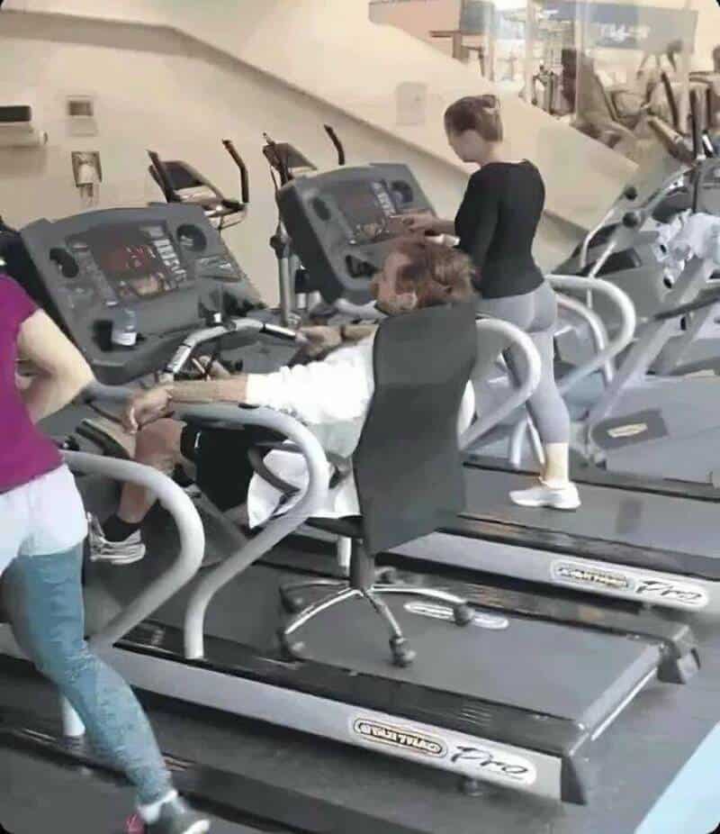 People exercising on treadmills in a fitness center.