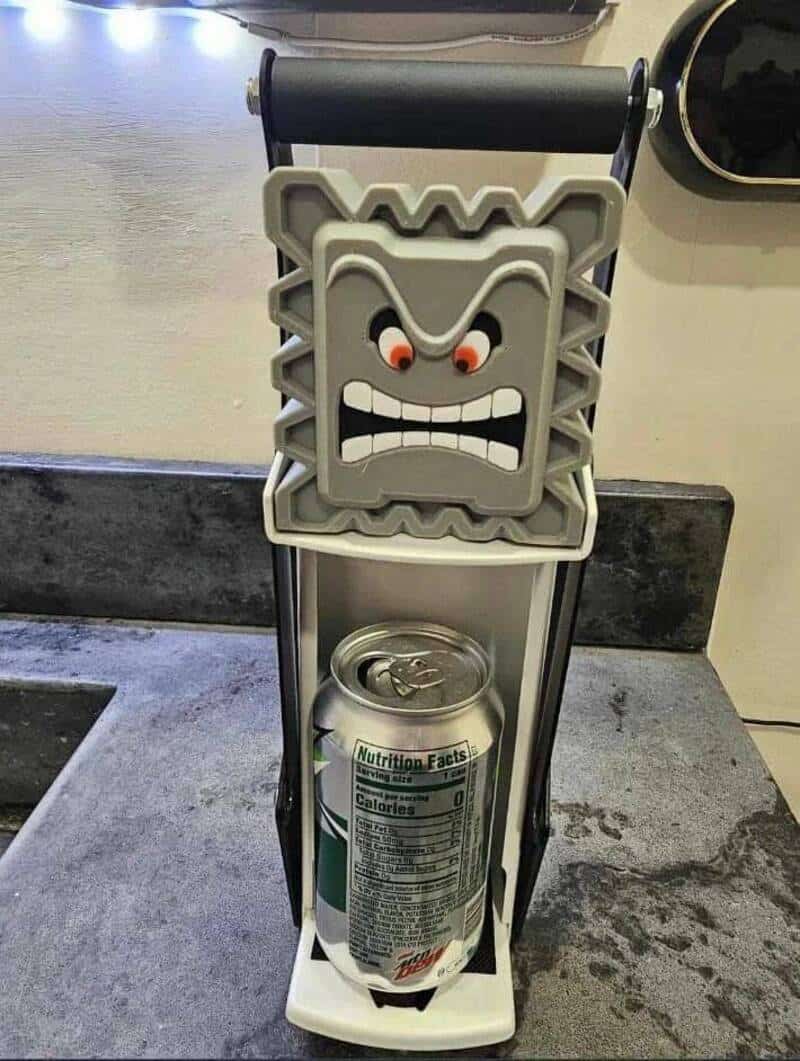 Tiki mug can holder with angry face design, perfect for fun kitchen or bar decor.