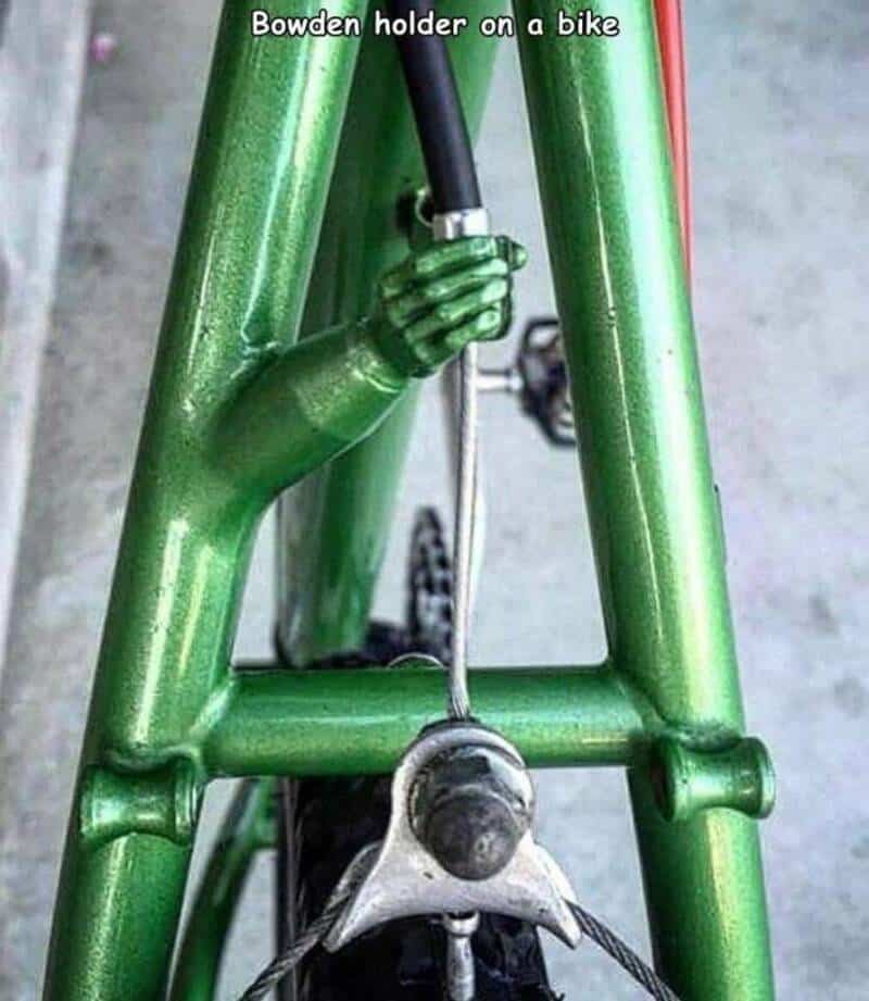 Bike frame with a hand-shaped holder on a bike, holding a bowden cable, painted in bright green.