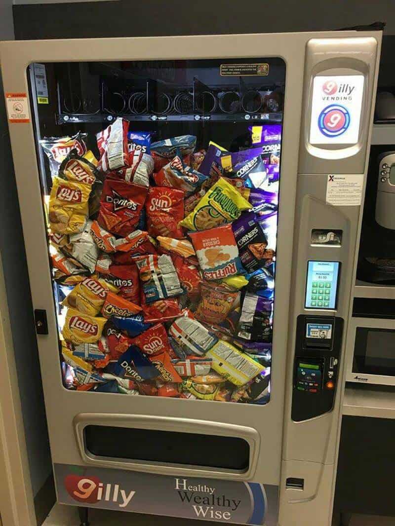 Vending machine filled with various snack bags including Lay's, Doritos, Sun Chips, and Cheetos.