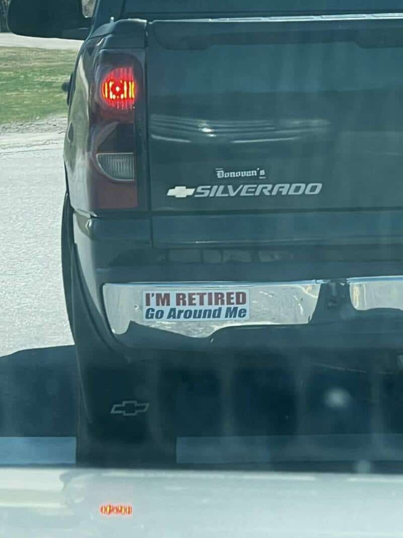 Chevrolet Silverado truck with humorous bumper sticker reading "I'M RETIRED Go Around Me".