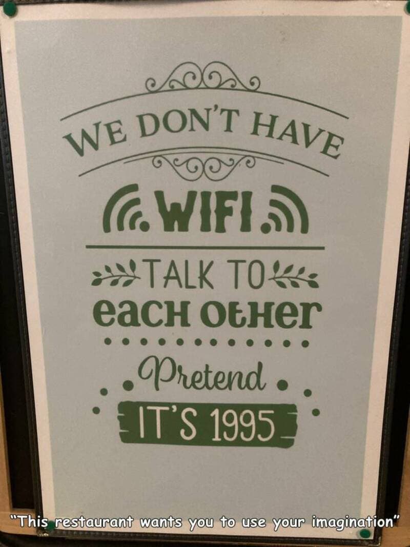 Sign reading "We don't have WiFi, talk to each other, pretend it's 1995".