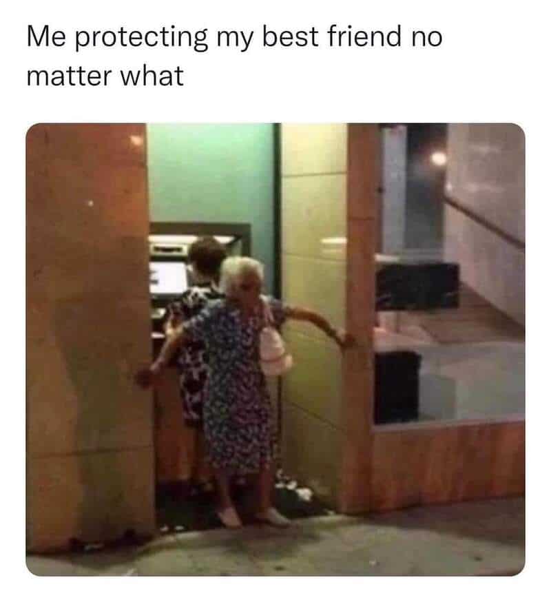 Elderly woman shielding a young girl with her body in a doorway.