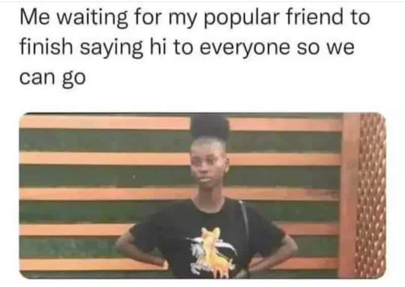 Young woman waiting with hands on hips, humorous meme about social patience.