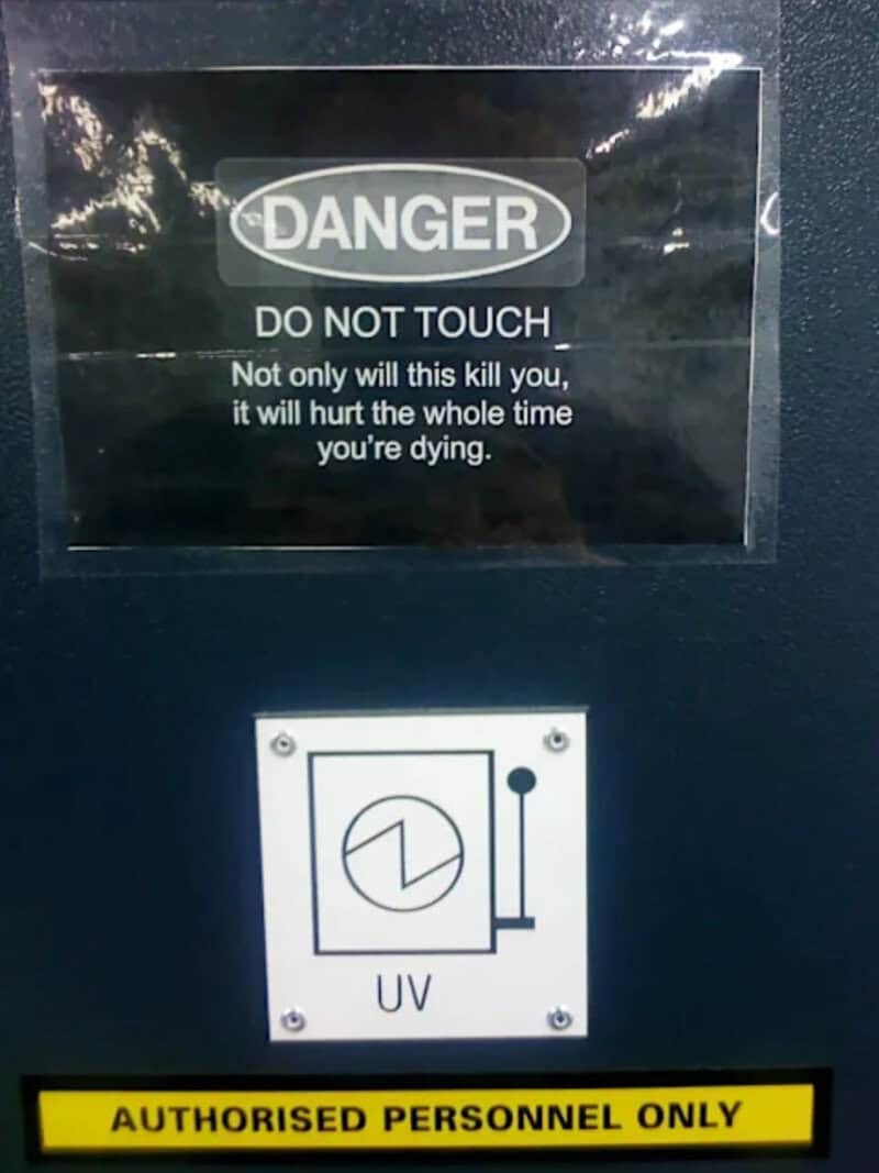 Caution sign warning about UV radiation with a graphic symbol and authorized personnel only label.