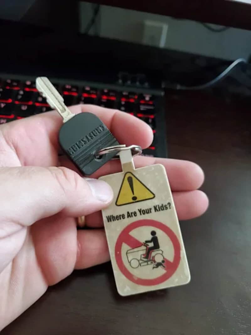 Keychain with warning sign and message for child safety.
