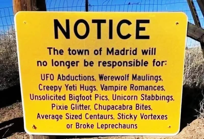 Bright yellow warning sign listing bizarre and humorous reasons for which Madrid will no longer be r.