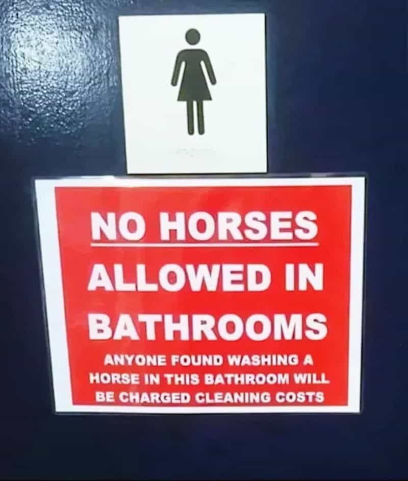 No horses allowed in bathrooms sign warning of cleaning charges.