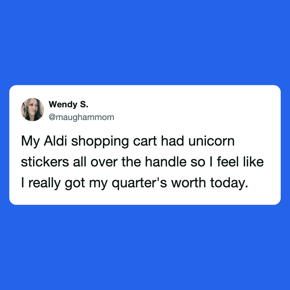 Aldi shopping cart decorated with colorful unicorn stickers on the handle.
