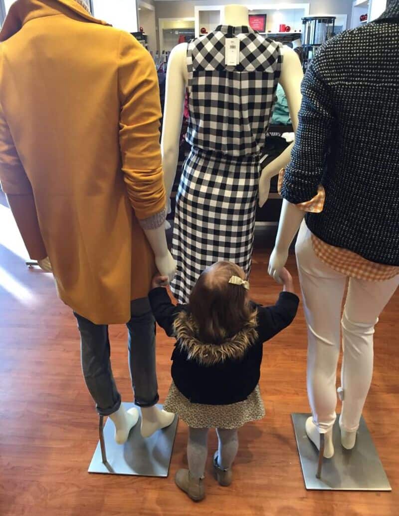 Mannequins showcasing casual and stylish outfits in a retail store.