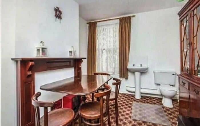Old-fashioned dining room with a wooden table, chairs, and a china cabinet.