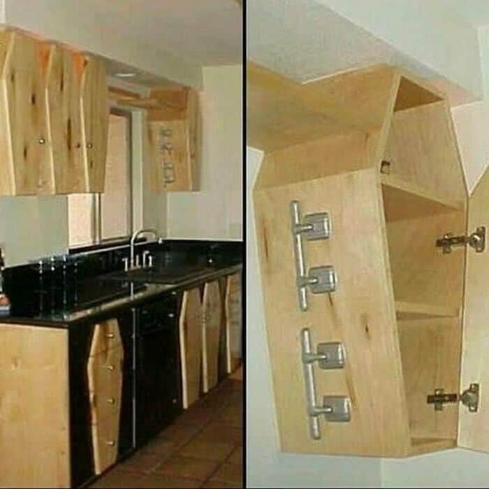 Unusual kitchen cabinet design with mismatched shelves and hardware.