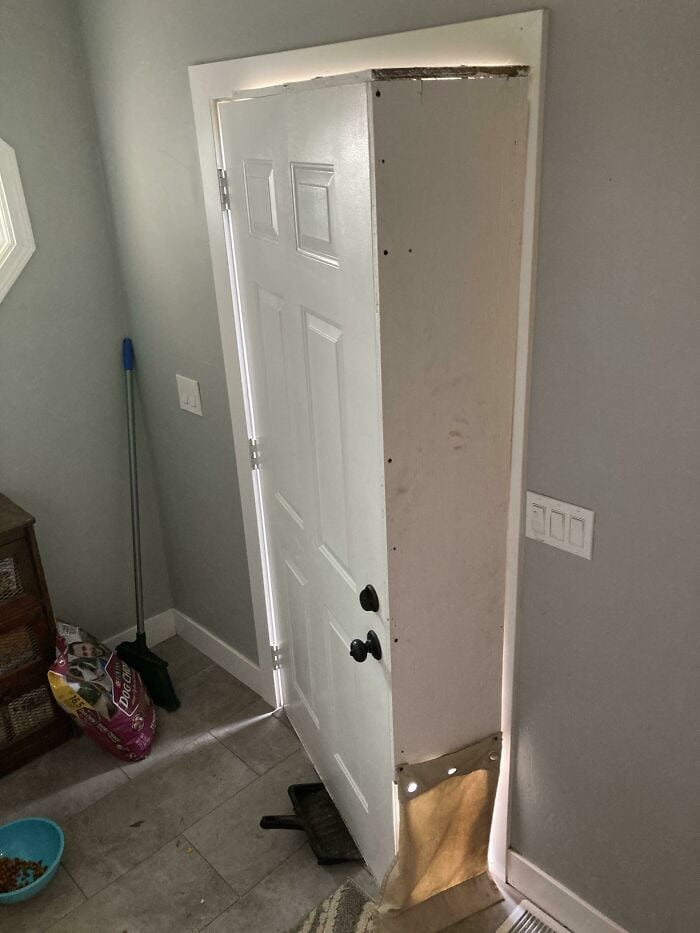 Poorly Installed Door Frame with Gaps and Misalignment.