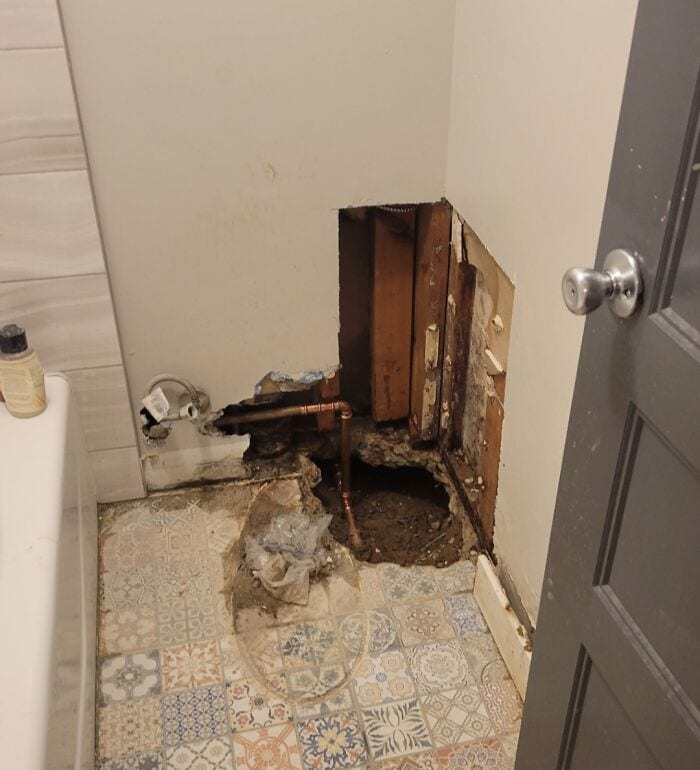 Exposed plumbing and wall damage in bathroom due to failed home improvement.