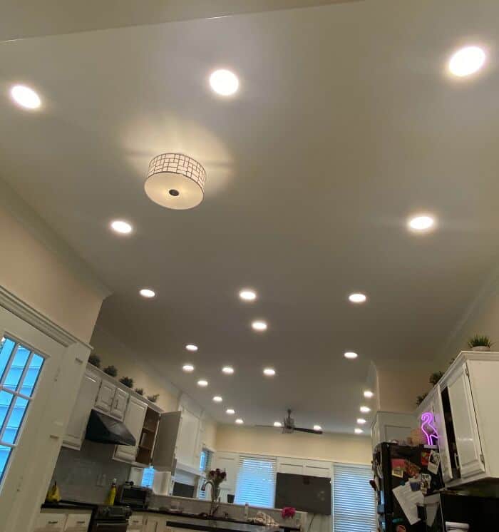Ceiling filled with multiple recessed lights in a contemporary kitchen setting.