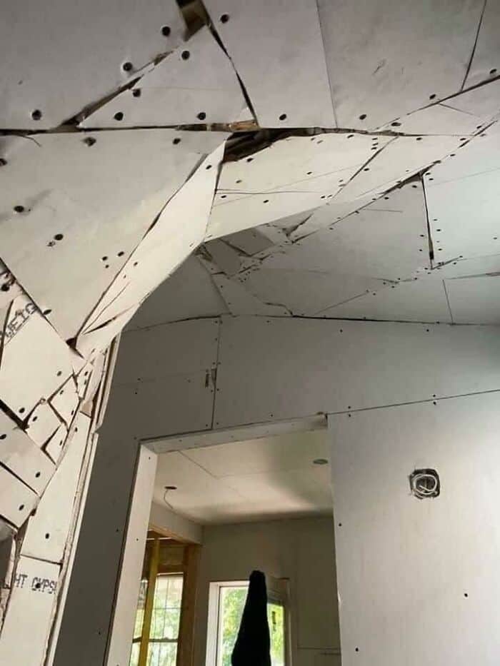Unfinished drywall ceiling with gaps and misaligned panels, highlighting poor home improvement work.