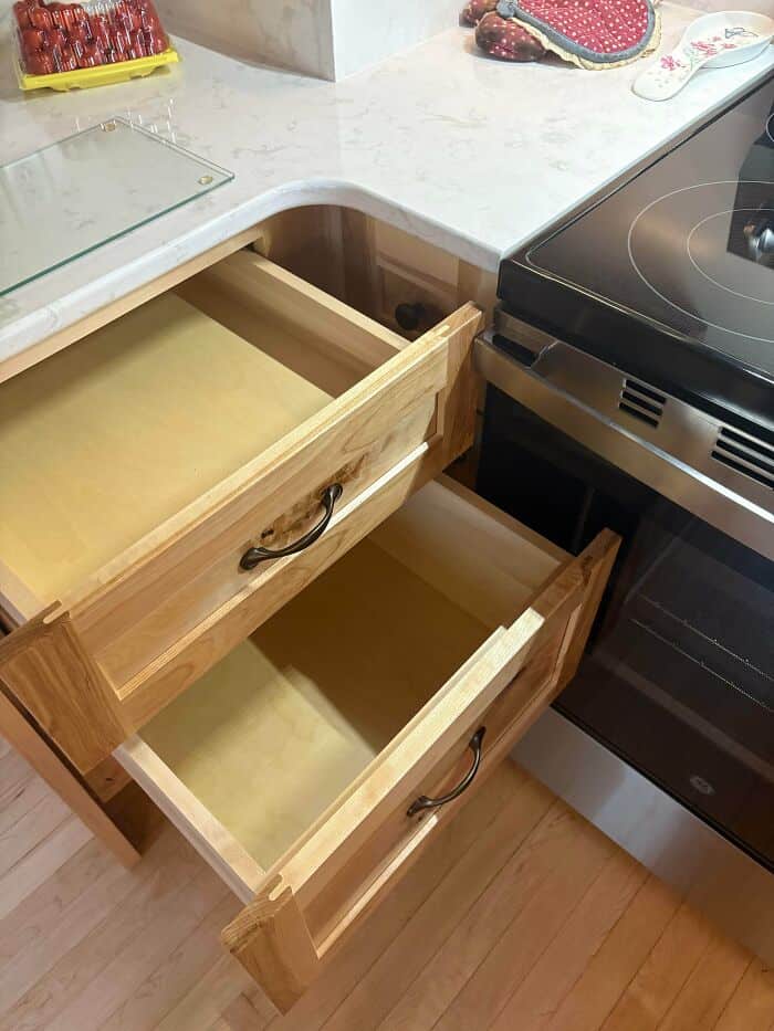 Incorrectly assembled kitchen drawers without handles, showing poor craftsmanship.