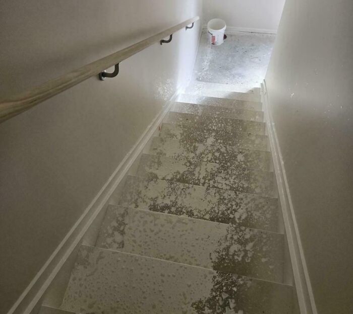 Dirty stairs with spilled paint or plaster, showing poor finishing work.