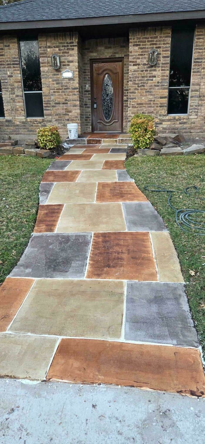 Uneven stone walkway leading to a front door with visible cracks and misaligned stones.