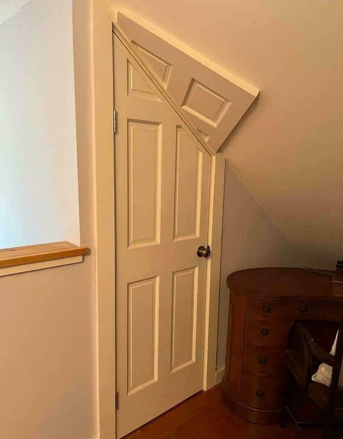 Door with a tilted top panel, creating a humorous and awkward appearance.