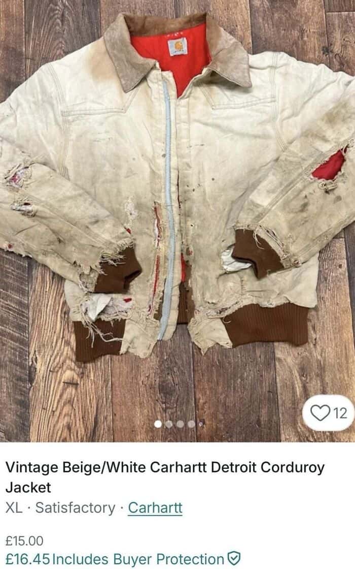 Vintage beige and white Carhartt Detroit corduroy jacket with distressed, torn fabric and frayed edg.