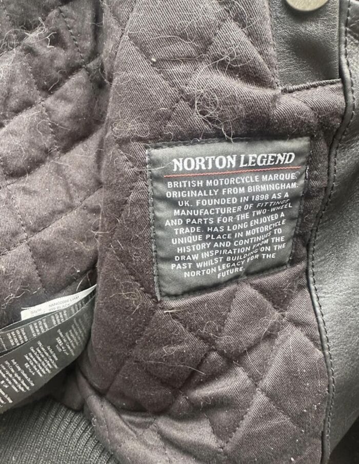 Norton Legend motorcycle jacket label with branding and history details.