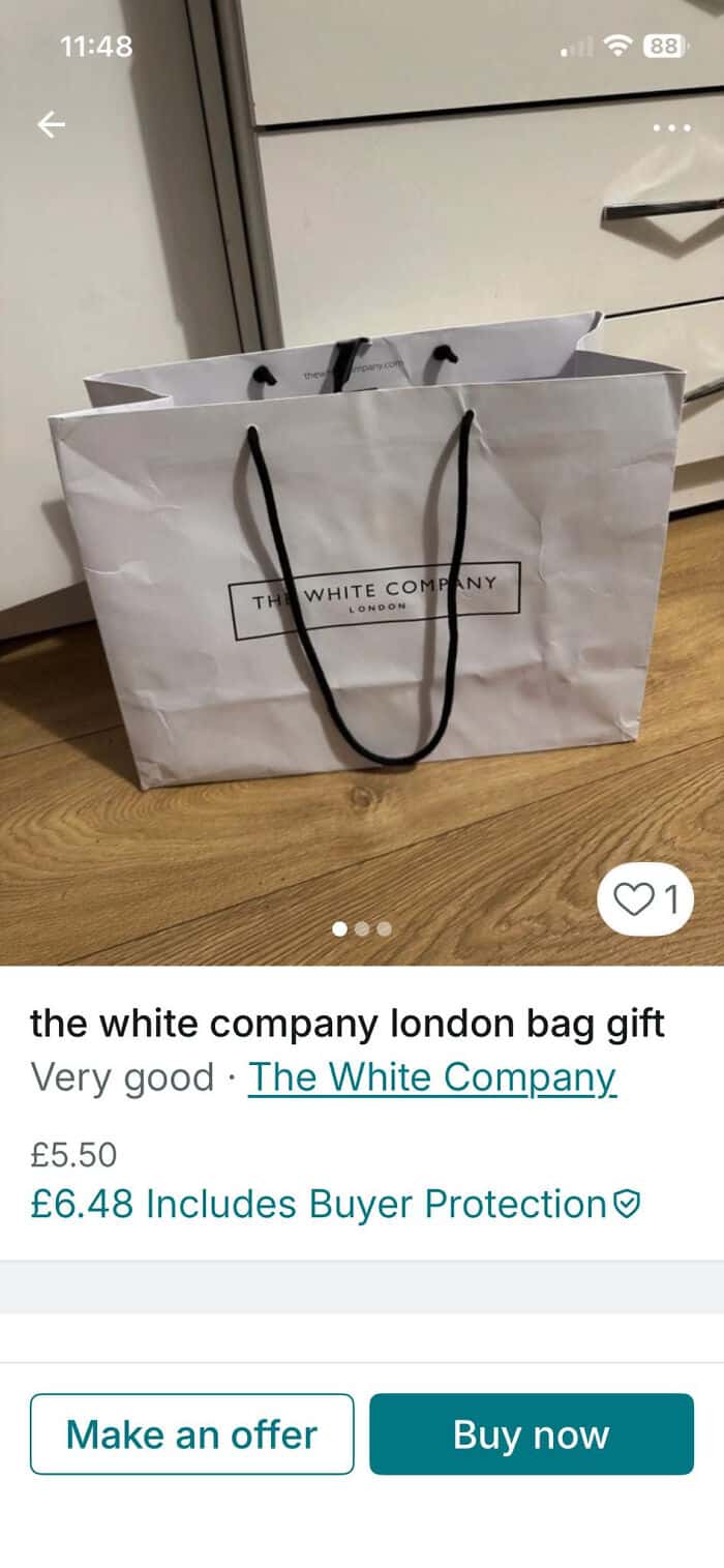 White Company London gift bag with black handles for shopping or gifting.