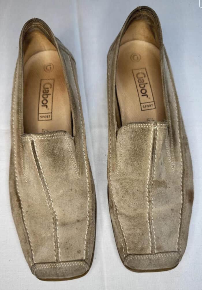 Pair of beige slip-on shoes with a suede finish, perfect for casual wear.