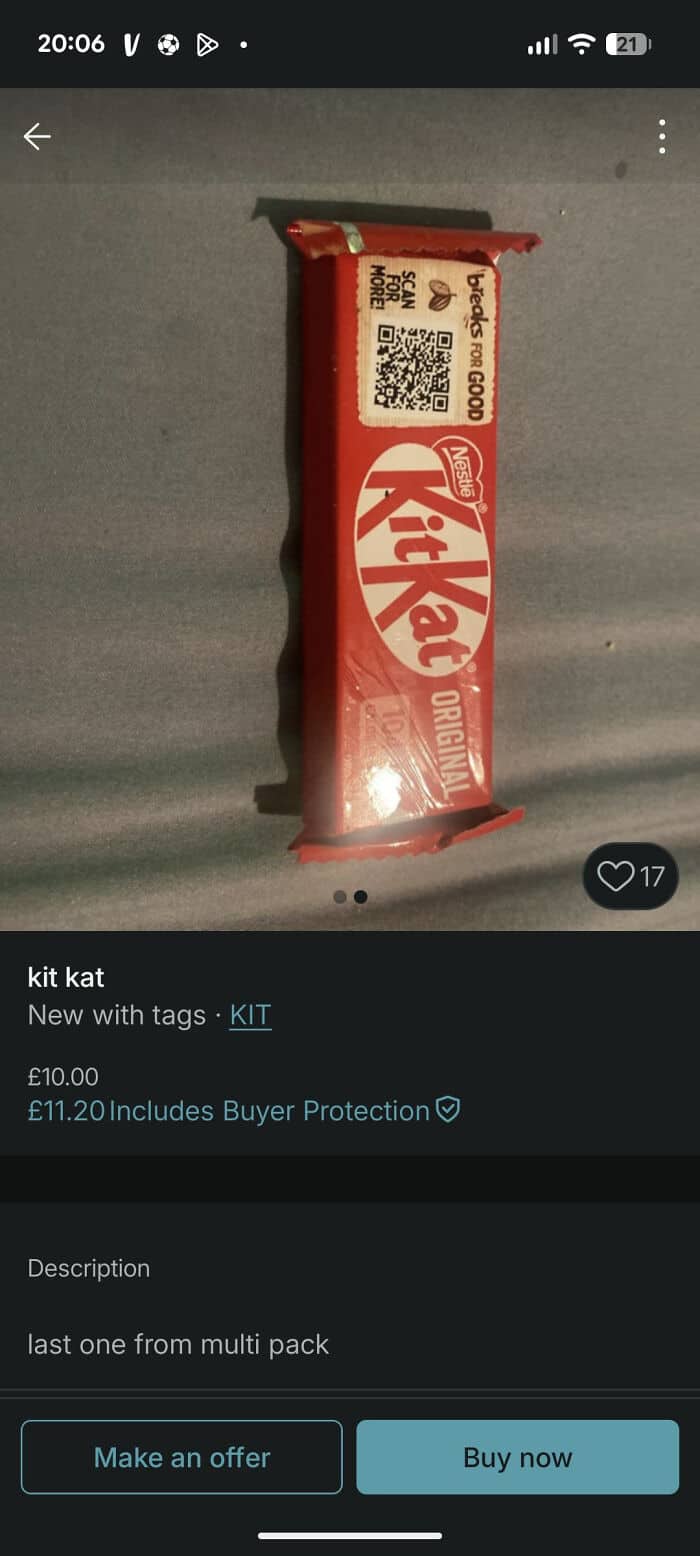 Kit Kat chocolate bar on a gray surface, close-up shot.