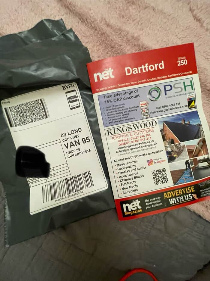 Shipping package with label and promotional flyer for local services, including discounts and advert.