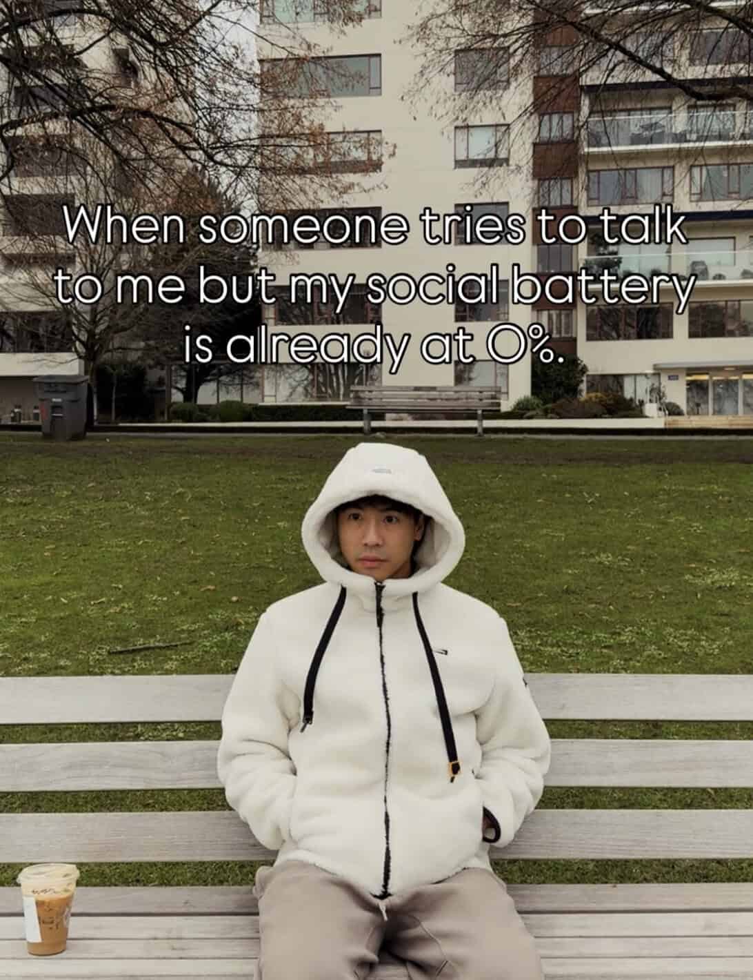 Avoided social interaction meme with a woman in a white hoodie sitting on a park bench, with a build.