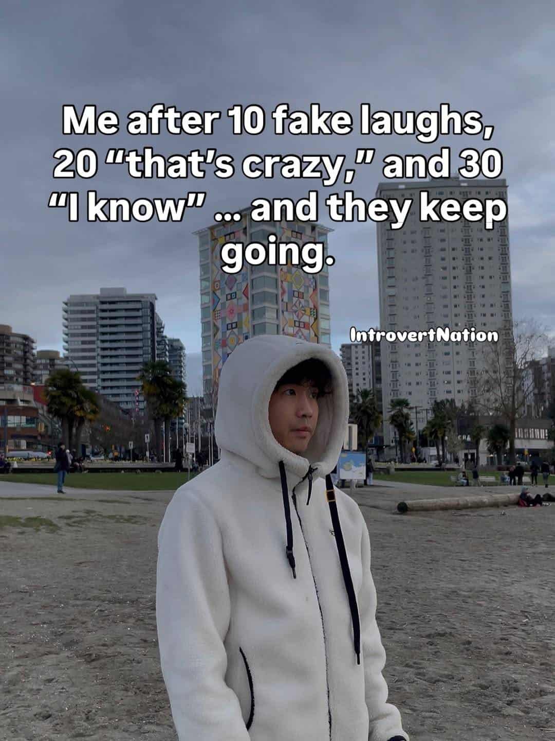 Person in white hoodie with cityscape background and humorous text overlay.