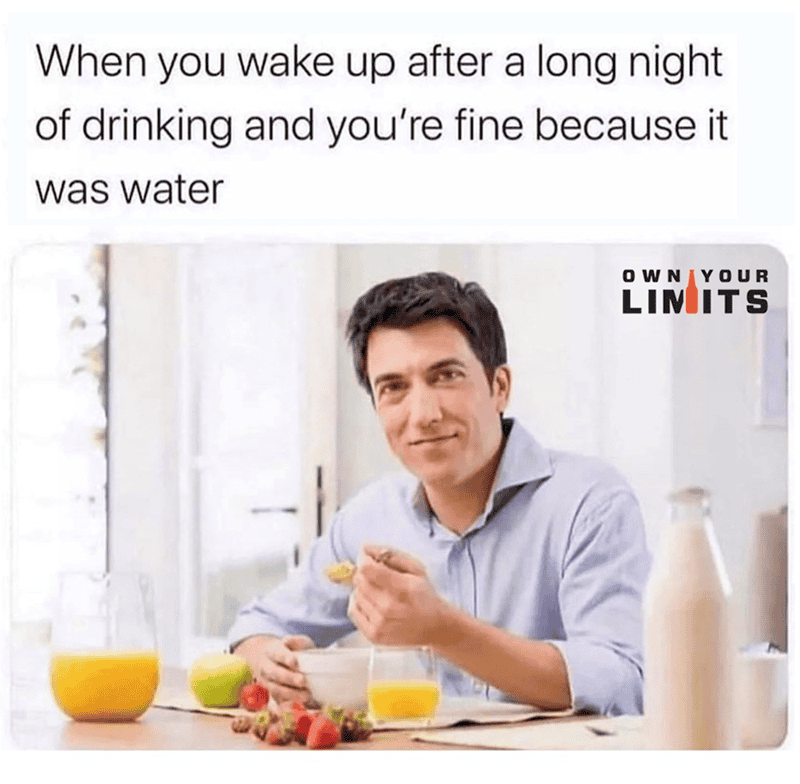 Man smiling at breakfast with water, fruit, and cereal, emphasizing hydration benefits.