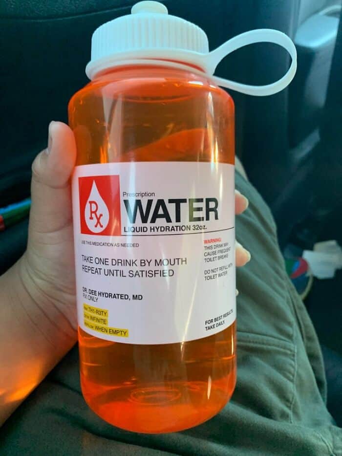 Clear orange hydration bottle with prescription label for medical water intake.
