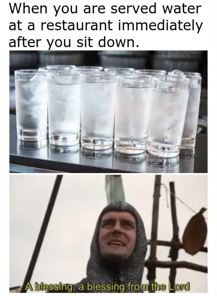 Row of empty water glasses on a tray in a restaurant setting.