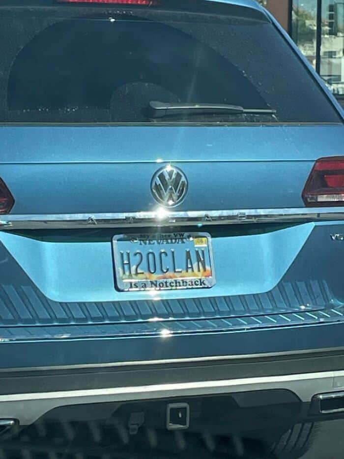 Blue Volkswagen SUV with custom license plate reading "H2OCLAN".