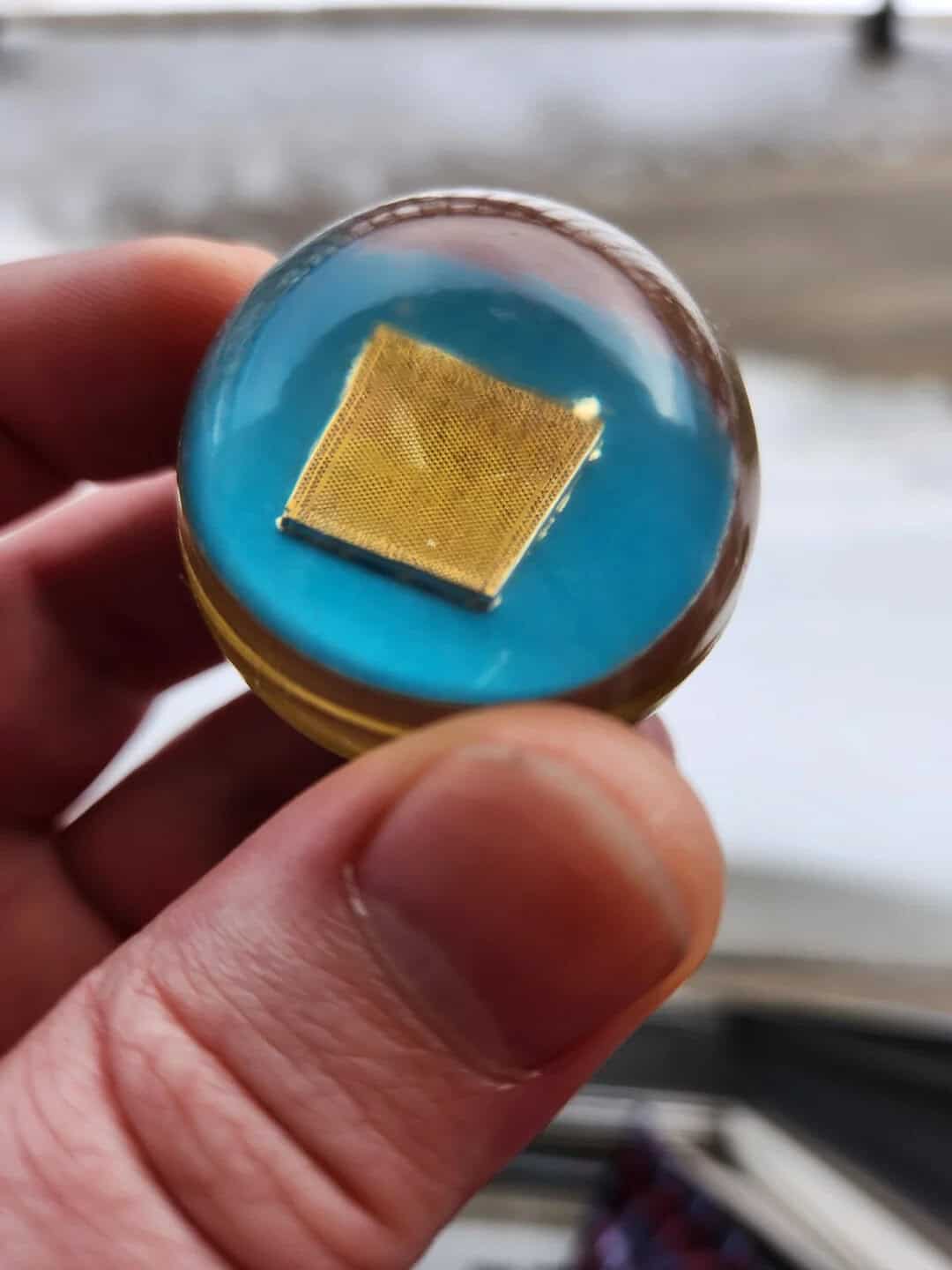 Microchip embedded in a glass sphere, showcasing technology and innovation.