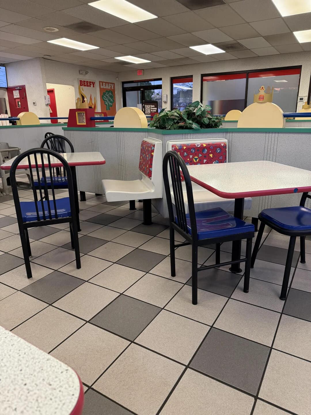 Bright, clean fast food restaurant interior with seating and decor.