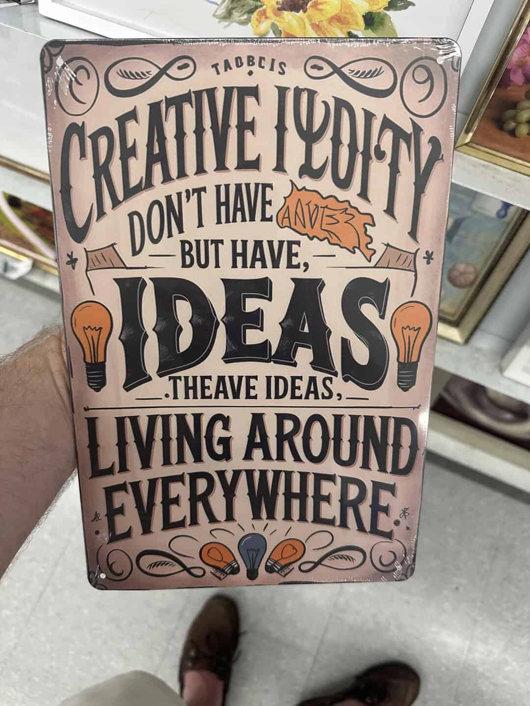 Motivational sign with quote about creativity and ideas, perfect for office or creative space decor.