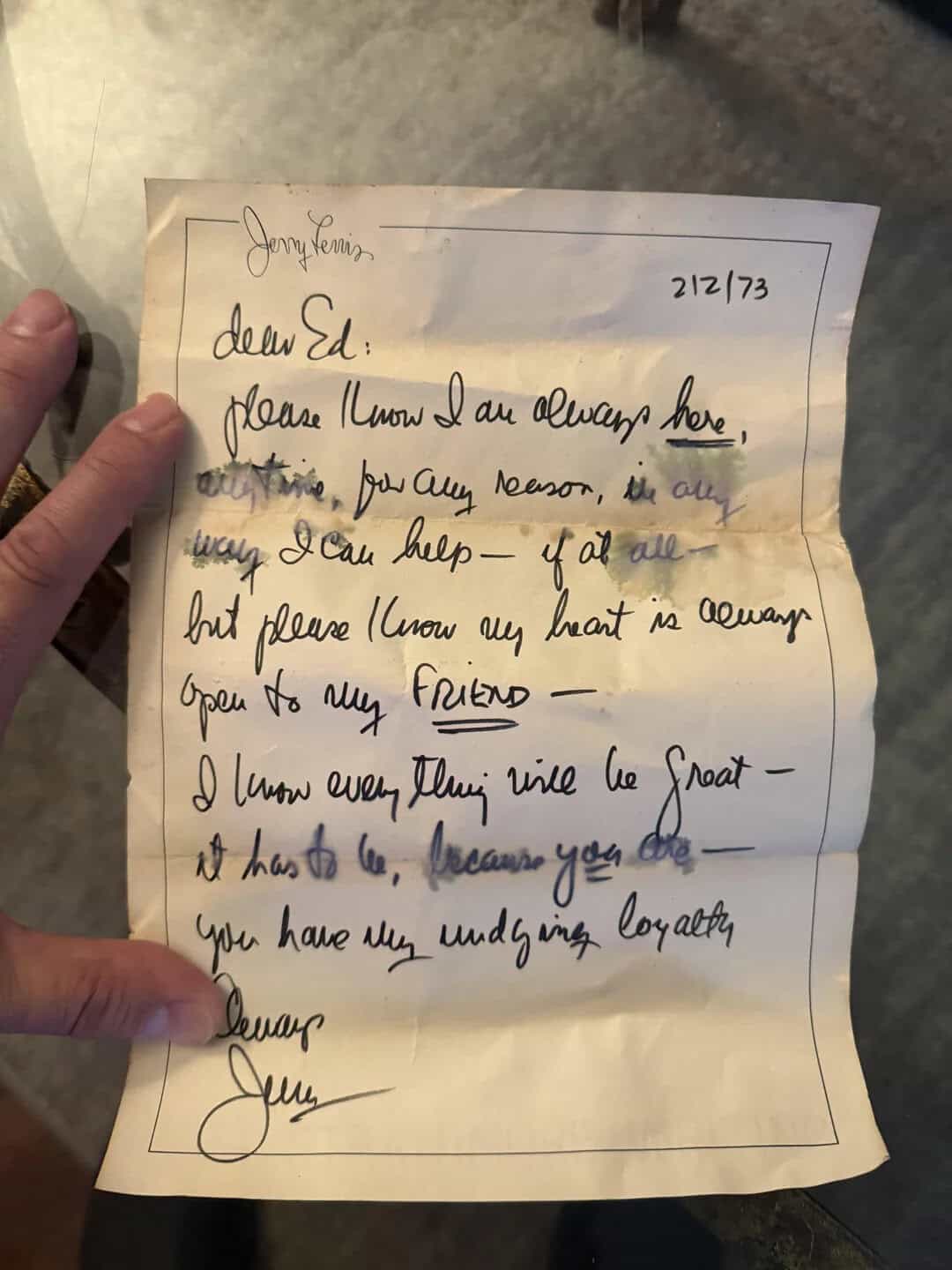 Handwritten letter with heartfelt message about loyalty and friendship, held by a person's hand.