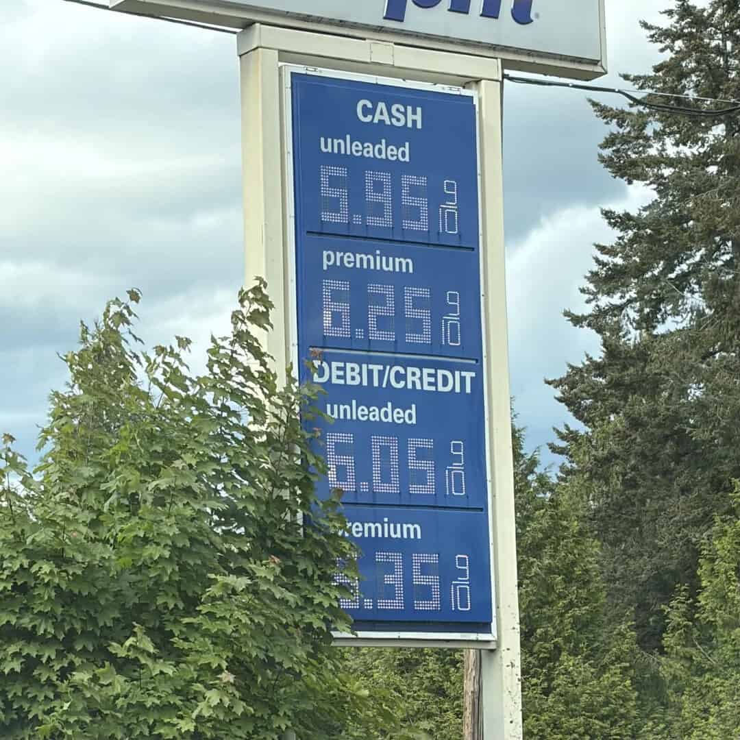 Gas station fuel prices for cash, debit, and premium fuel in a rural setting.
