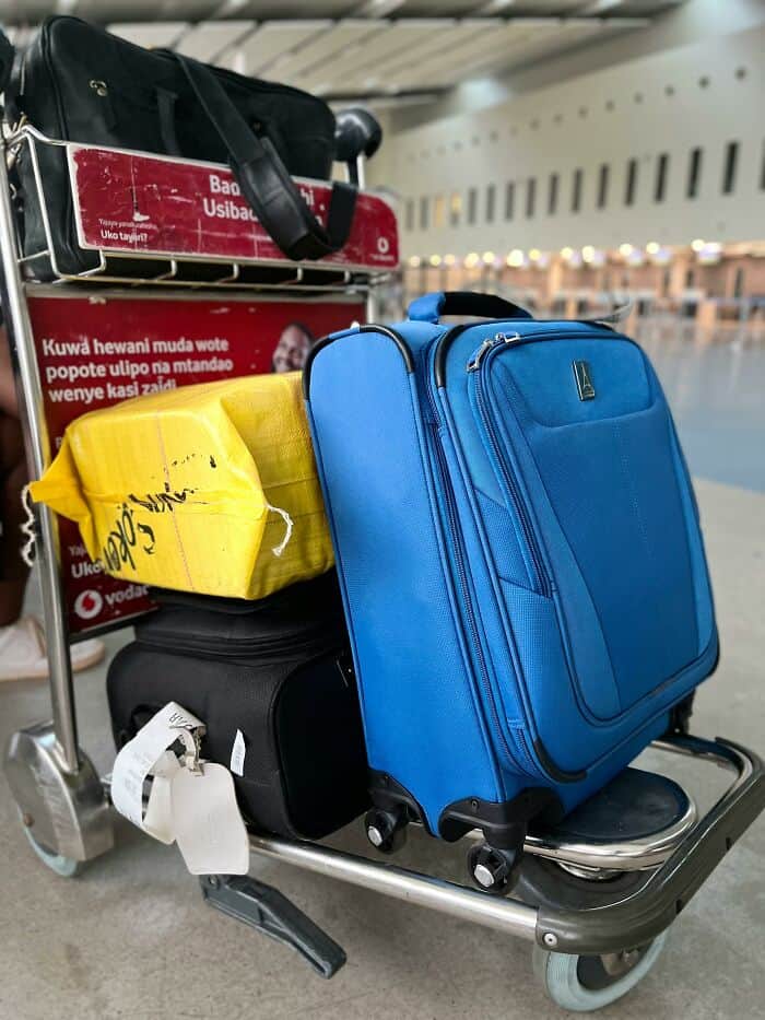 Travel luggage and bags on airport trolley for baggage check.