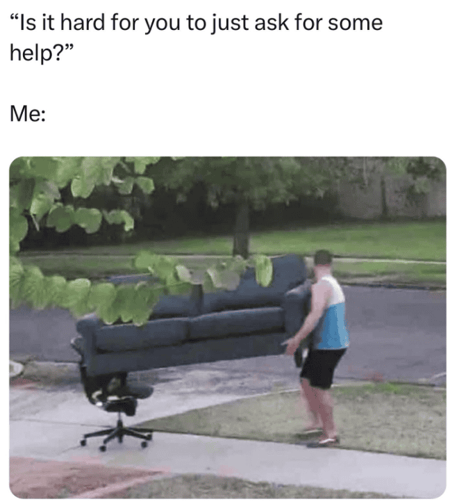 Man pushing a sofa on wheels outdoors, creating a humorous illusion of moving furniture.