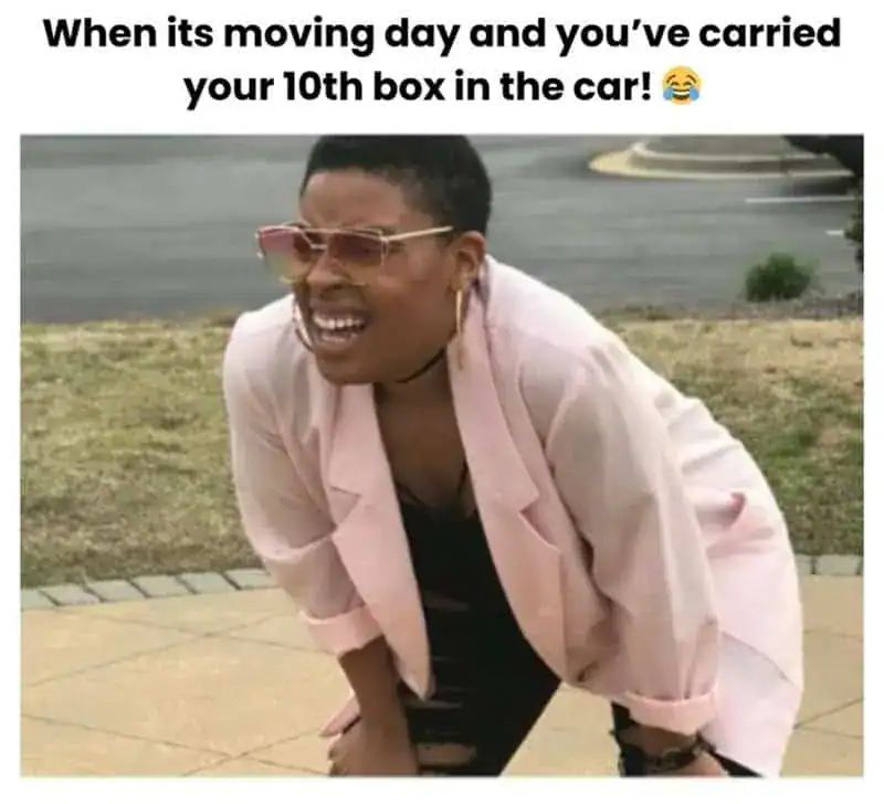 Woman laughing on moving day, carrying her 10th box in the car, humorous moment.